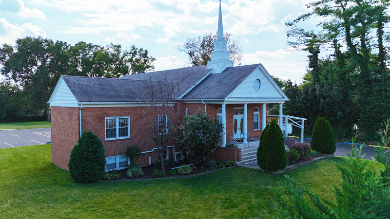 Calvary Bible Baptist Church brick building with white steeple in daylight in Willingboro, New Jersey