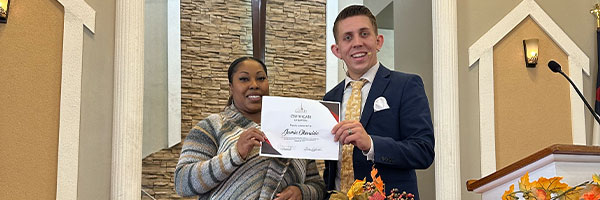 Pastor Philip Middleton presenting certificate to church member after completing discipleship program